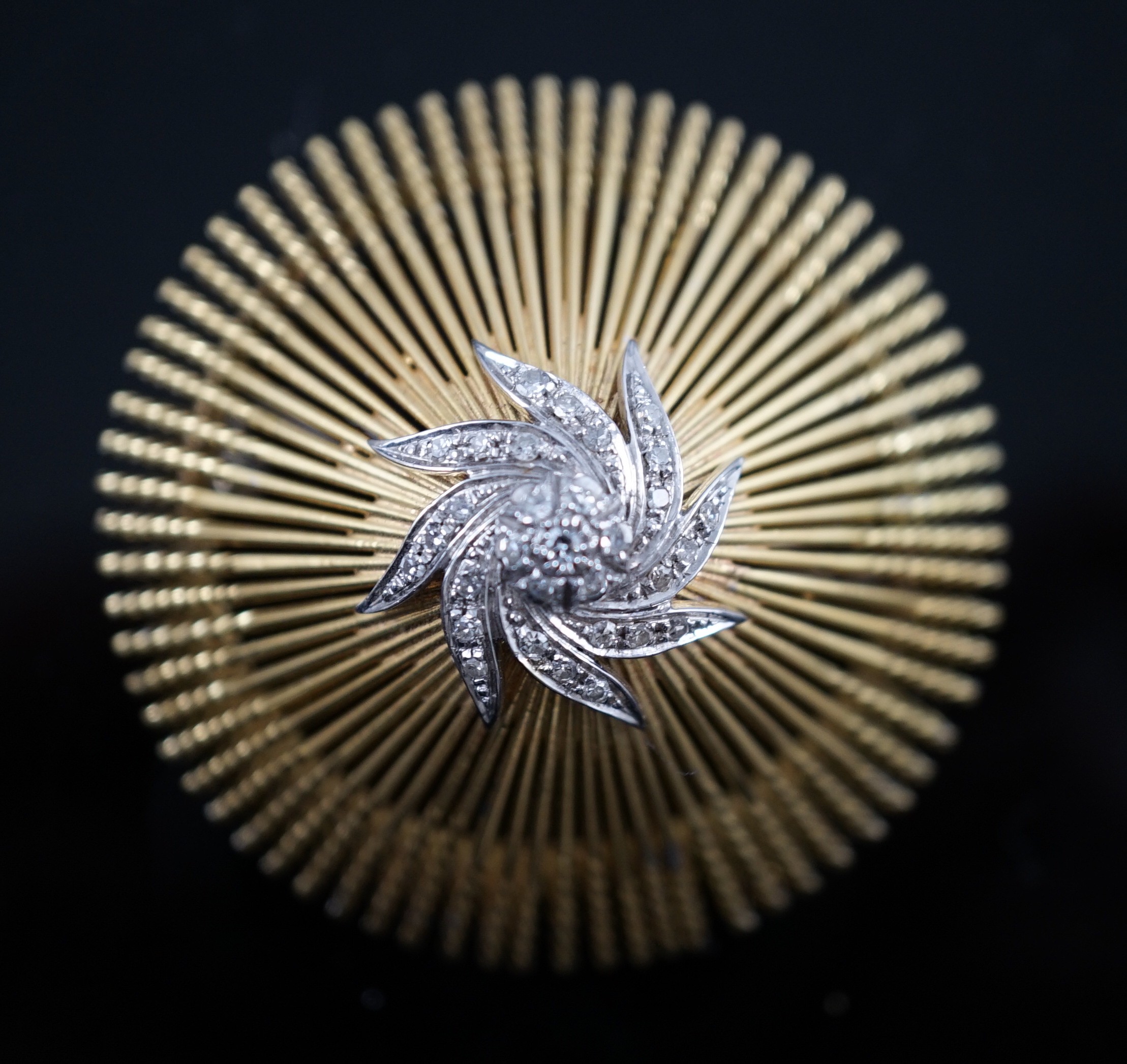 A modern stylish Italian pierced 18k and diamond chip set domed brooch